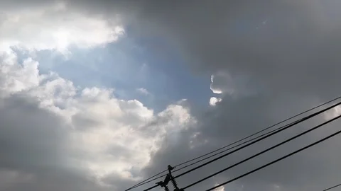 Gray overcast clouds on blue sky before rain or storm. Power lines in the sky. Stock Footage 96279919