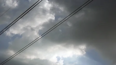 Gray overcast clouds on blue sky before rain or storm. Power lines in the sky. Stock Footage 96280725