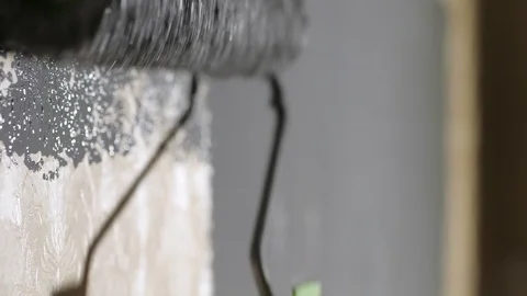 Gray paint roller moves up and down wall. Wall painting concept 库存影片 122911959