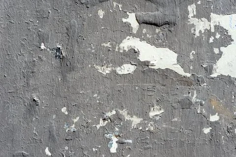 Gray painted torn posters on a wall close up texture background Stock Photos
