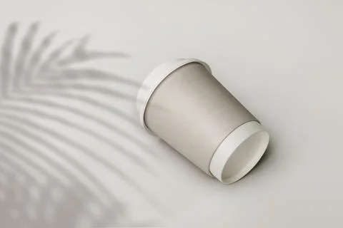 Gray paper cup with palm leaf shadow Stock Photos