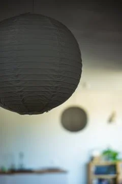 Gray paper lantern in softly lit minimalist Madeira interior scene Foto stock