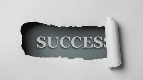 Gray paper is torn over blue background with word "success", stop motion. Stock Footage 121359634