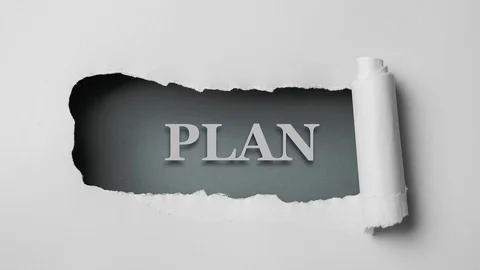 Gray paper is torn over blue background with word "plan", stop motion. Stock Footage 121359649