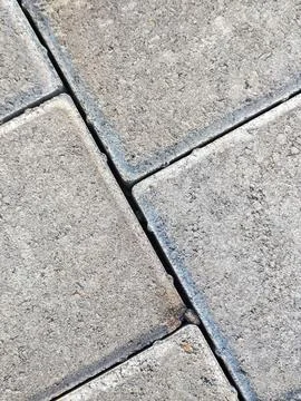 Gray paving blocks texture closeup on a sidewalk pavement Фото