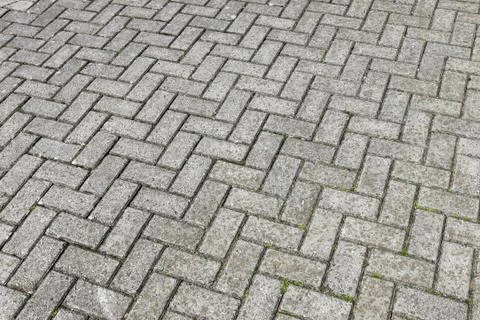 Gray paving cobblestone blocks pattern background. Stock Photos