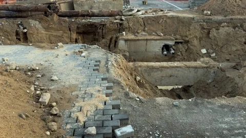 Gray paving stones installation at construction site with excavation Vidéo 340515123