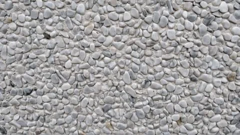 Gray pebble wall close up Stock Photos