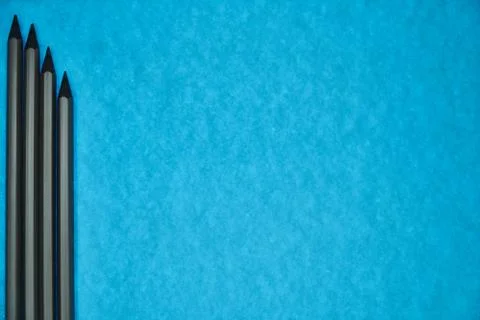 Gray pencils on blue background Stock Photos