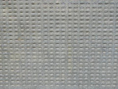 Gray perforated material with a rigid structure Stock Photos