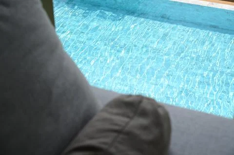 Gray pillow put on bed, pool view Stock Photos