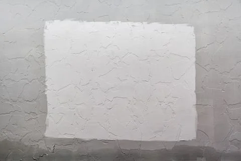 Gray plaster wall background with white rectangle in center, Mockup. Stock Photos