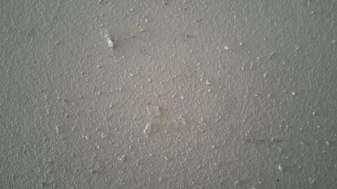 Gray plaster wall texture with rough surface and tiny debris particles Stock Photos