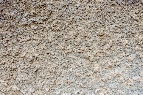 Gray plastered wall, patterned background, indented protruding texture Stock Photos
