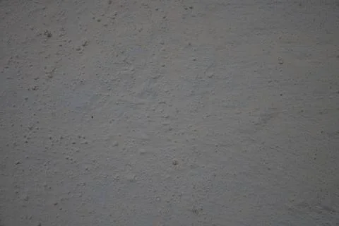 Gray plastered wall texture with subtle yellow undertones Stock Photos