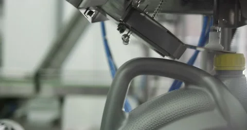 Gray plastic bottles move along a conveyor line to fill and pack motor oil. Stock Footage 166284217
