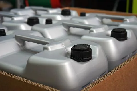 Gray plastic cans with black caps. Selected focus. Stock Photos