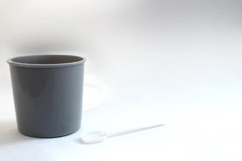 Gray plastic crap container and scoop for medical examination for various dis Stock Photos