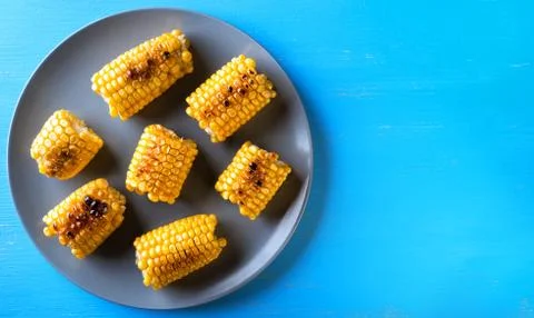 Gray plate with baked corn Stock Photos