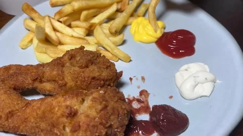 Gray plate with crispy fried chicken legs, french fries, ketchup, mayonnaise Stock Footage 278842779