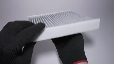 A Gray Protective Plate Being Held Firmly by Hands That Are in Gloves Vidéo 303811088