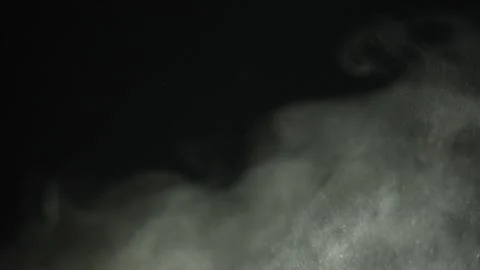 Gray puffs of sand dust fly through the air in slow motion 動画素材 233634153