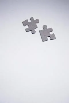Gray puzzles on a white background. isolated. Top view, copy space. Foto stock