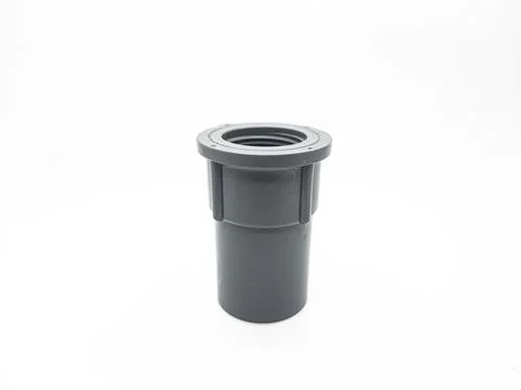 Gray pvc adapter fitting used for plumbing on a white seamless backdrop Stock Photos