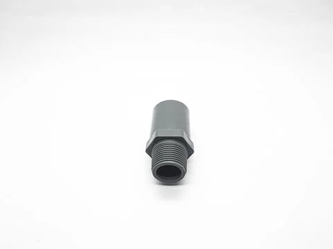 Gray pvc adapter fitting used for plumbing connections on a white background Stock Photos