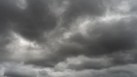 Gray rain clouds. Weather before the rain. Waiting for the storm and thunder. Stock Photos