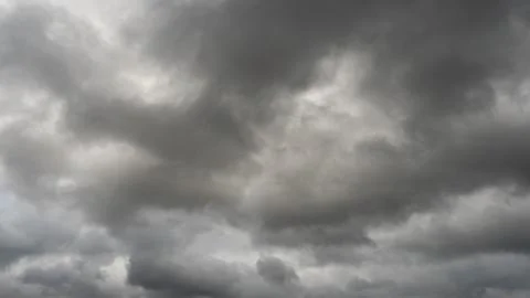 Gray rain clouds. Weather before the rain. Waiting for the storm and thunder. Stock Photos