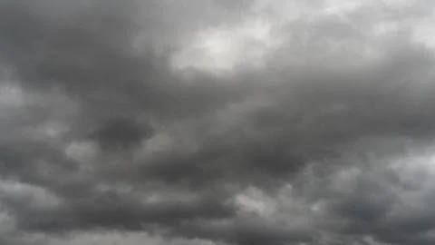 Gray rain clouds. Weather before the rain. Waiting for the storm and thunder. Stock Photos