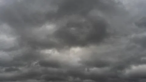 Gray rain clouds. Weather before the rain. Waiting for the storm and thunder. Stock Photos