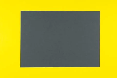 Gray rectangle on a yellow background. Demonstration of trendy colors 2021 库存照片