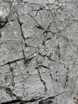 Gray rock or stone surface texture with cracks. Stock Photos