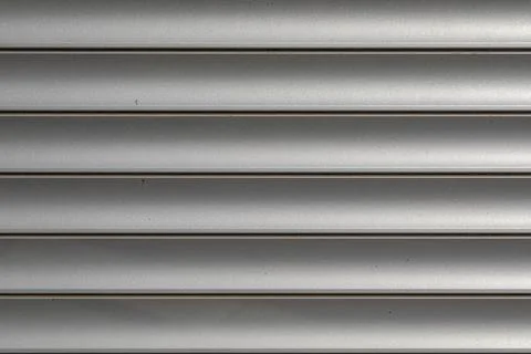 Gray roller shutters. Folding door made of rolled steel. texture  Stock Photos