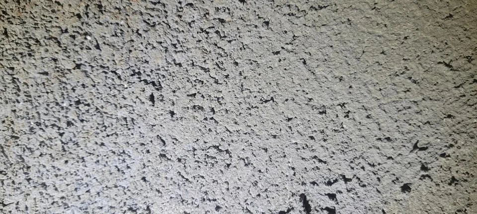 Gray rough plaster wall texture with porous concrete finish. Natural archit.. Stock Photos