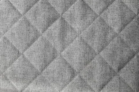 Gray rough quilted fabric pattern, background photo texture Foto stock