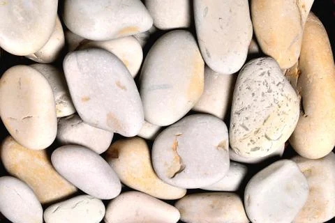 Gray rounded stones of heterogeneous structure, background Stock Photos