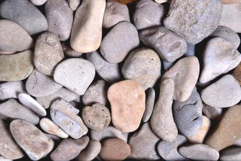 Gray rounded stones of heterogeneous structure, background Stock Photos