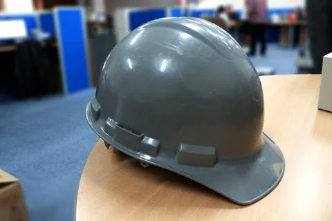 Gray safety helmet on the table in the construction office Stock Photos