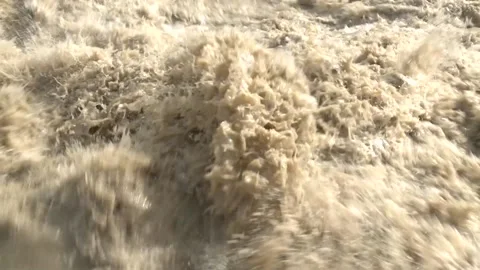 The gray, seething and boiling water of the deep river flows with a roar. Stock Footage 154422541