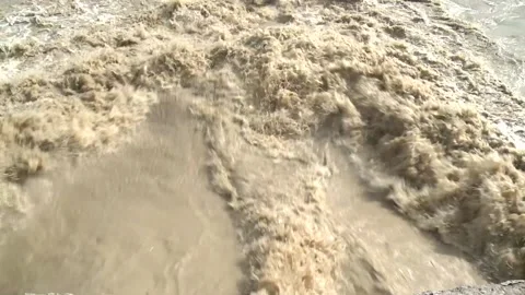 The gray, seething and boiling water of the deep river flows with a roar. Stock Footage 154422543