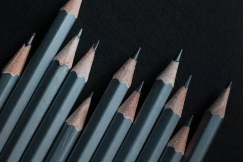 Gray sharpened pencils isolated on black background. Stock Photos