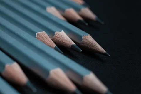 Gray sharpened pencils isolated on black background. Stock Photos