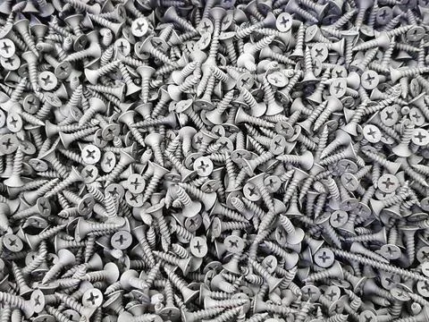Gray short self tapping screws a lot. Texture background. Stock Photos