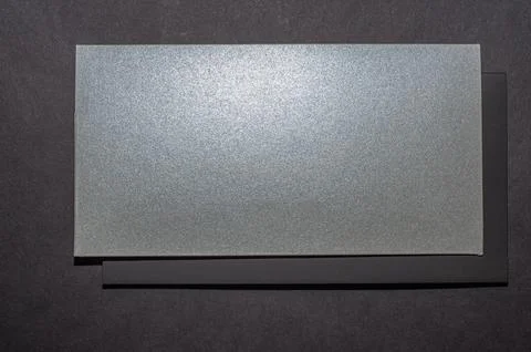 Gray, silver envelope on a black flat background, luxury corporate identity a Stock Photos