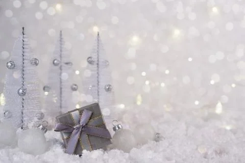 Gray silver gift box and Christmas decorations on a frosty winter background. Stock Photos
