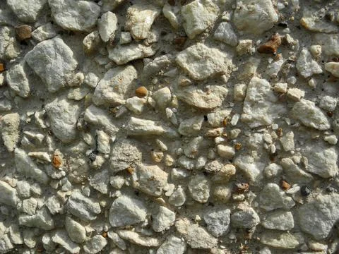 Gray small rocks ground texture. Gravel pebbles stone seamless texture. Backg Stock Photos