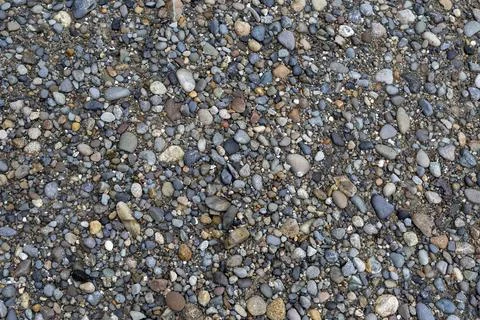 Gray small rocks ground texture. black small road stone background. Stock-Fotos